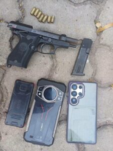 A Beretta pistol, loaded with a magazine containing four rounds of 9mm ammunition, alongside live rounds and spent cartridges, were recovered at the scene. [Photo/DCI]